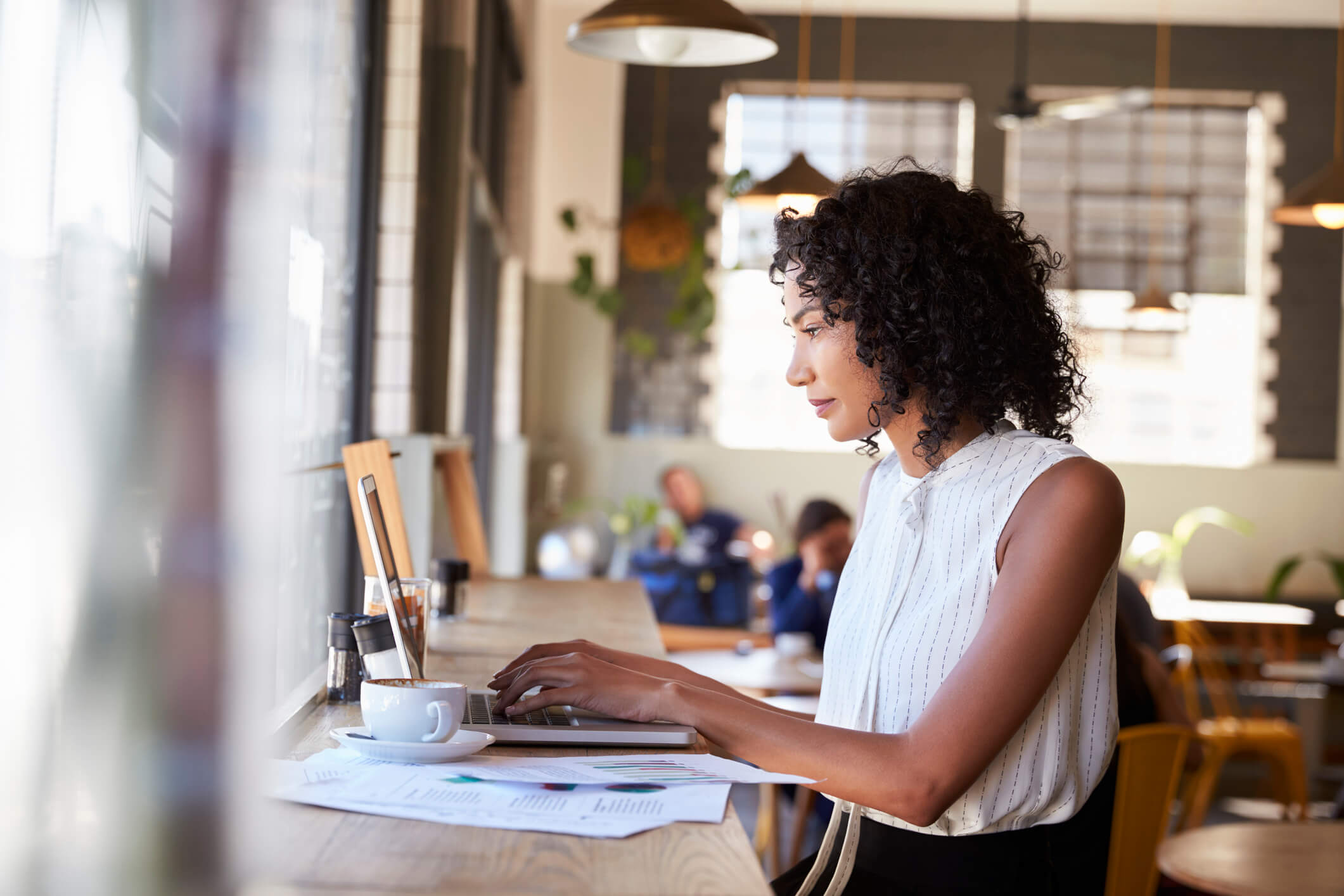 Woman setting up Facebook ads on her laptop