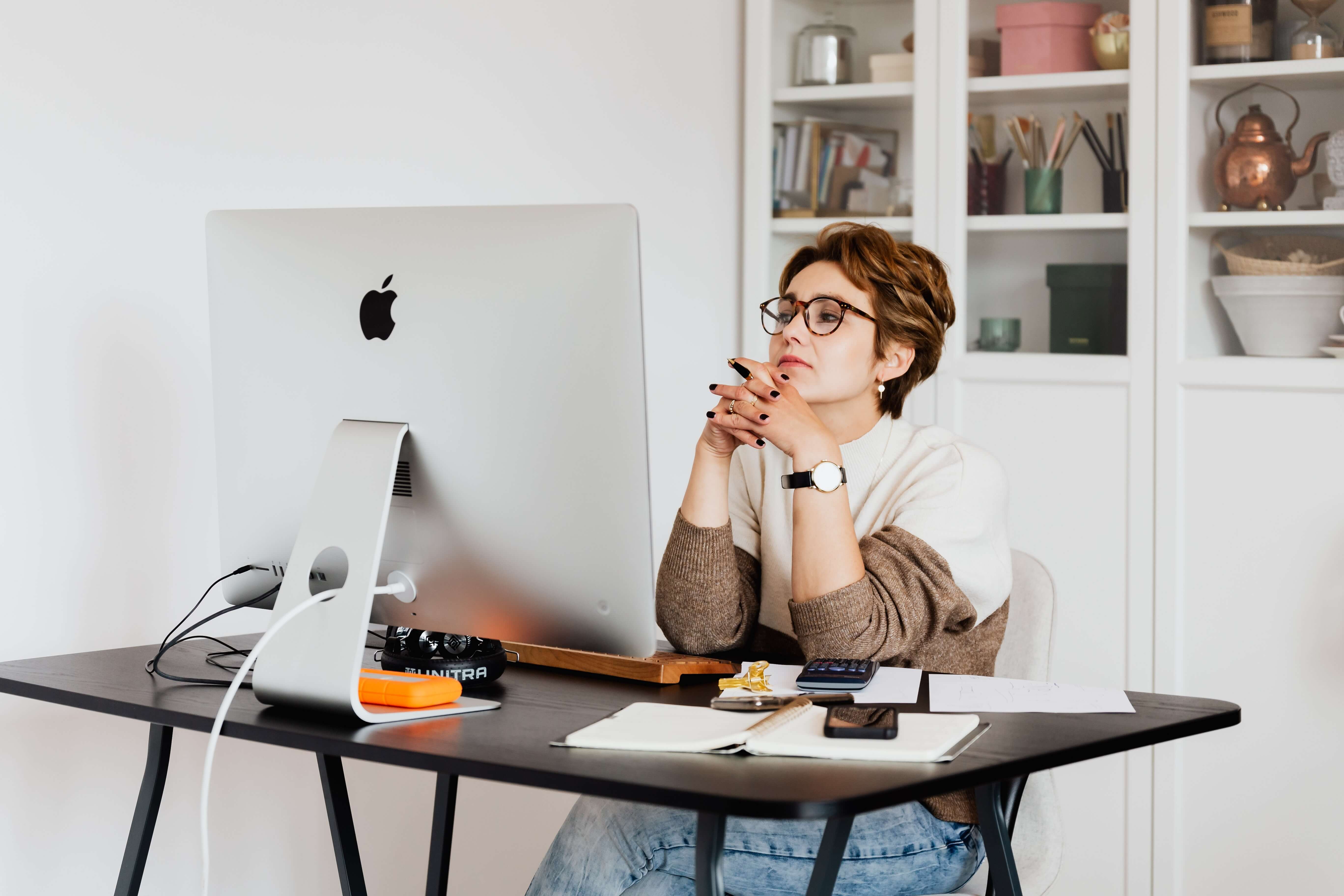 woman looking at her emails on her desktop computer